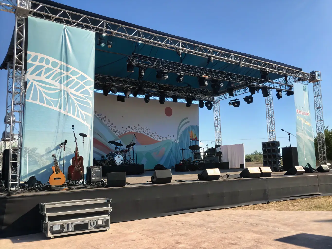 A photograph of a well-equipped performance stage with professional lighting and sound, ready for a DIVIN-supported artist to perform.