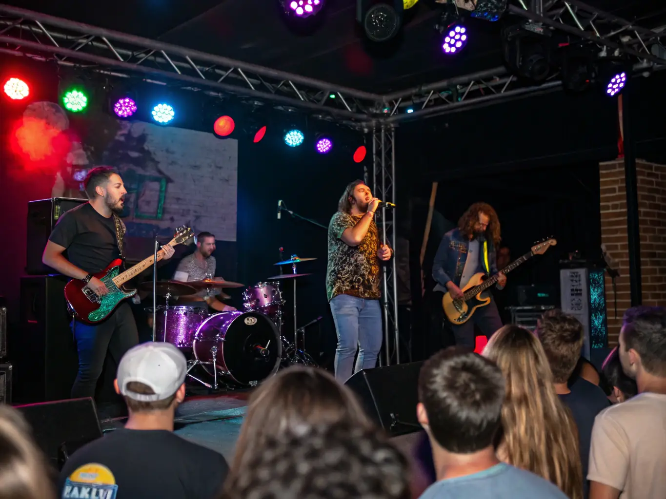 A dynamic image of a live music performance at a DIVIN-organized event, highlighting the organization's commitment to showcasing local talent and providing access to cultural experiences.
